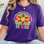 Wholesale In A World Be Kind Graphic Tee - Team Purple Tee